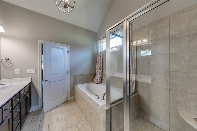 bathroom featuring plus walk in shower, lofted ceiling, vanity, and tile patterned floors