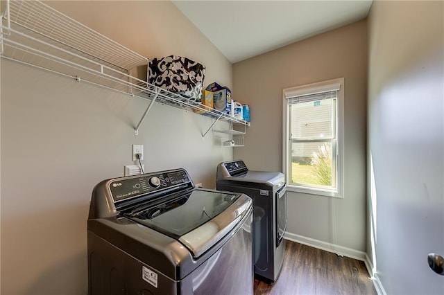 laundry room featuring washing machine and dryer and dark wood-type flooring