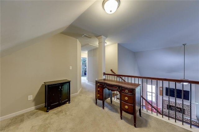 carpeted home office featuring lofted ceiling