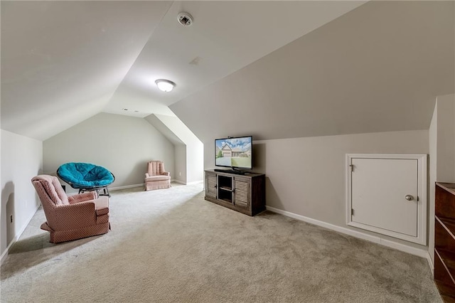 additional living space featuring lofted ceiling and carpet