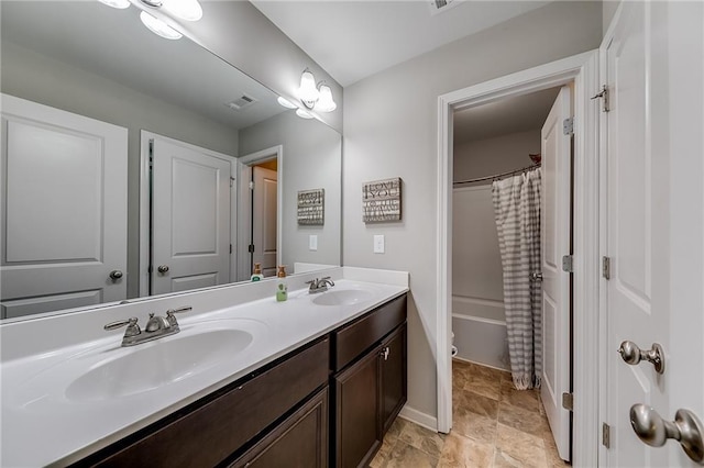 full bathroom featuring vanity, shower / tub combo, and toilet