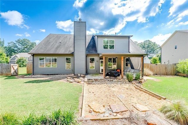 back of property with a patio and a lawn