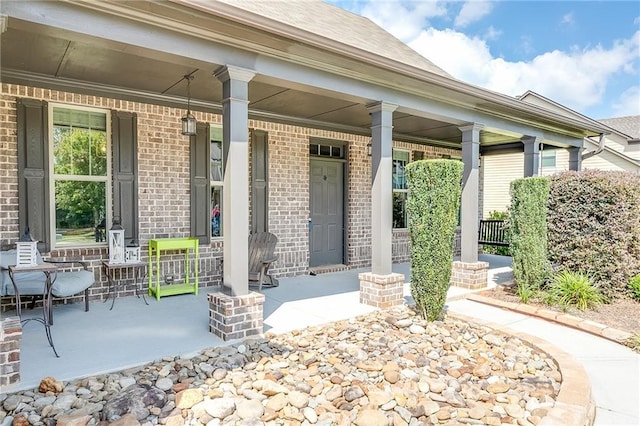 view of exterior entry with a porch