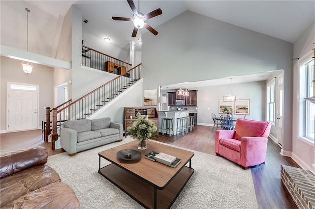 living room with hardwood / wood-style floors and high vaulted ceiling