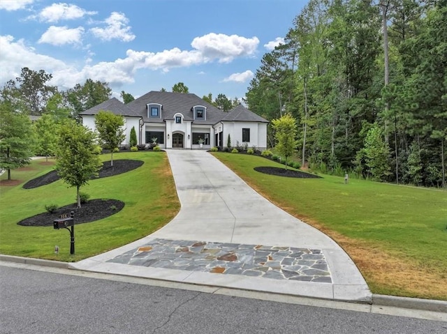 french country home featuring a front lawn