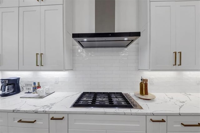 kitchen with wall chimney exhaust hood and white cabinetry