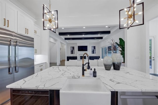 kitchen featuring beamed ceiling, built in fridge, beverage cooler, a center island, and hanging light fixtures