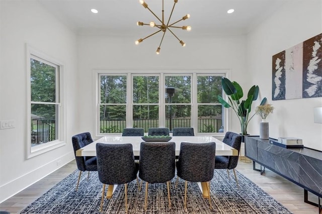 dining space featuring wood-type flooring and a notable chandelier