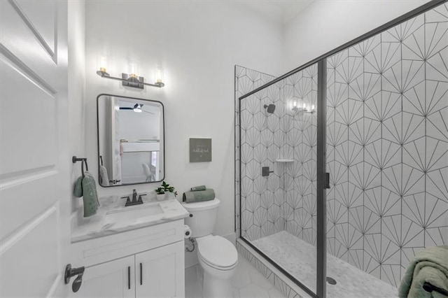 bathroom featuring vanity, a shower with shower door, tile patterned floors, and toilet