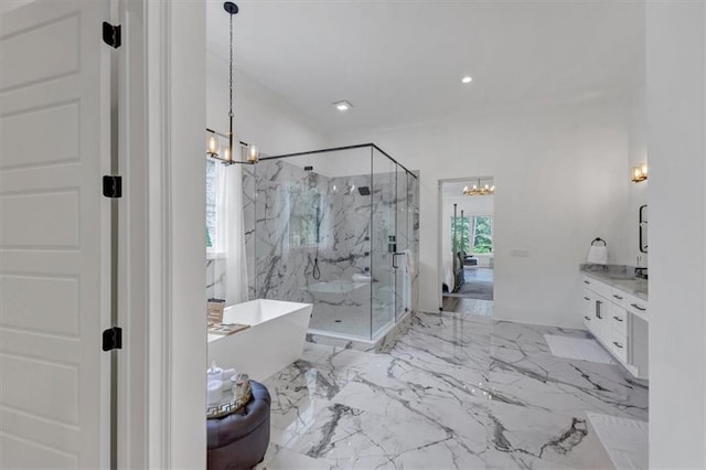 bathroom featuring vanity, an inviting chandelier, and shower with separate bathtub