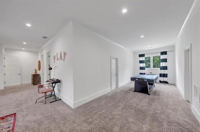 interior space with ornamental molding and carpet