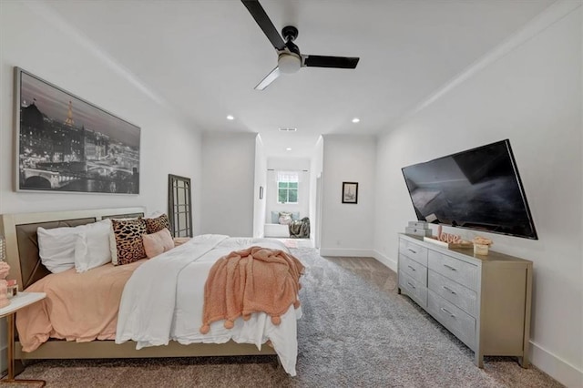 bedroom with ceiling fan and light carpet