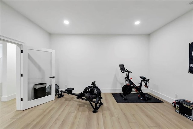 workout area featuring light wood-type flooring