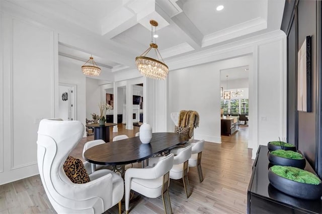 dining area with coffered ceiling, an inviting chandelier, beamed ceiling, crown molding, and light wood-type flooring