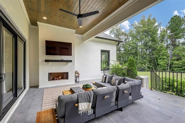 view of patio with a balcony and an outdoor fireplace