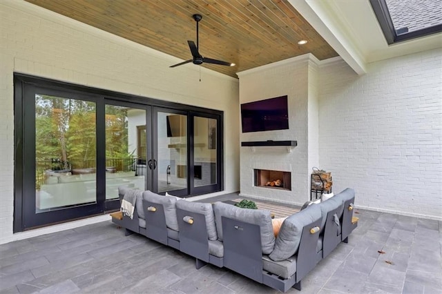 view of patio with a brick fireplace and ceiling fan