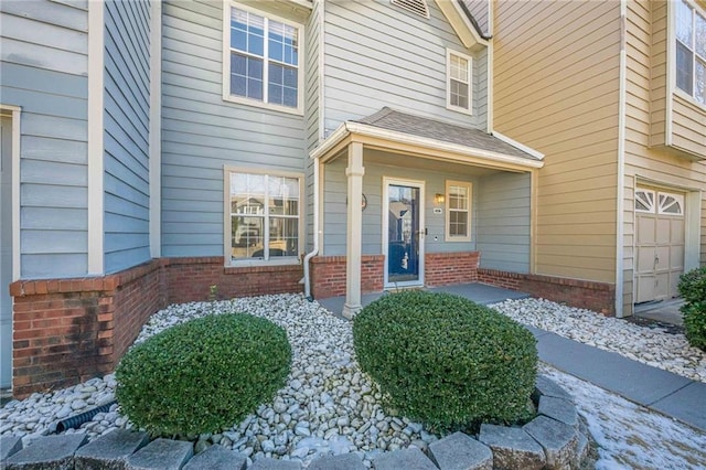 view of exterior entry featuring a garage