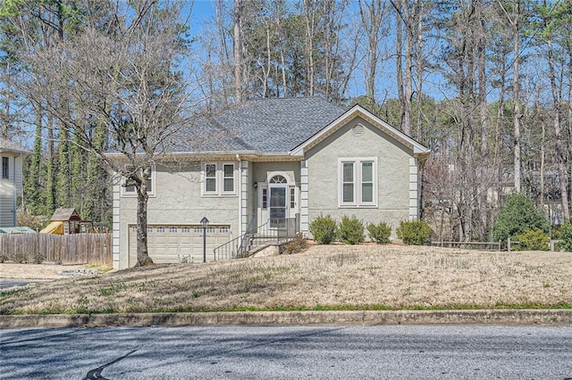 view of front facade with an attached garage and fence