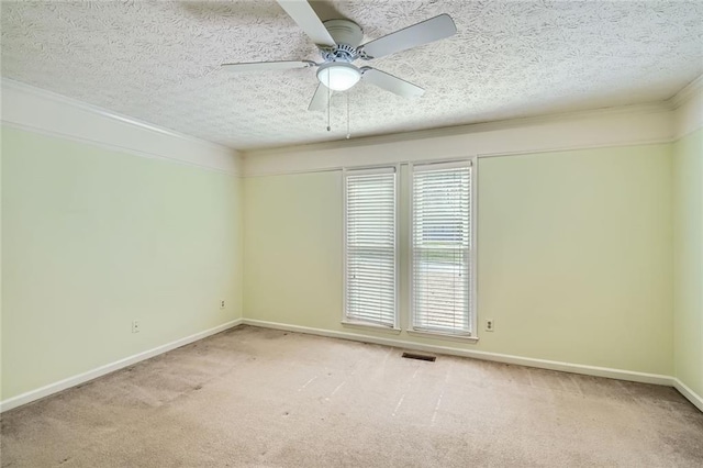 empty room with ceiling fan, a textured ceiling, and carpet