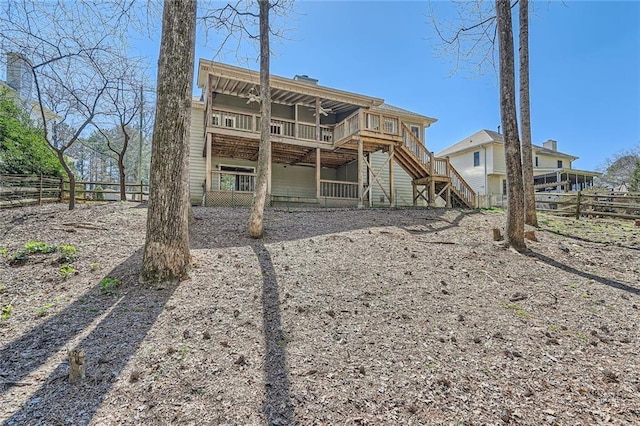 back of property with stairway and fence