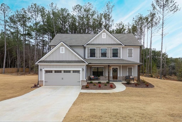 craftsman house with a garage, a porch, and a front lawn