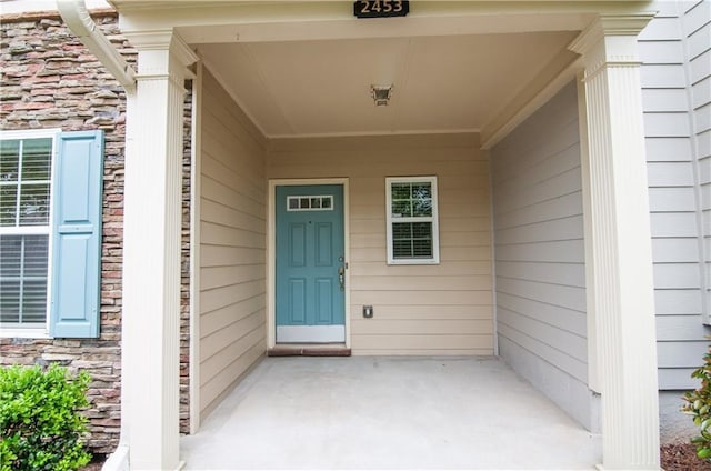 property entrance with stone siding