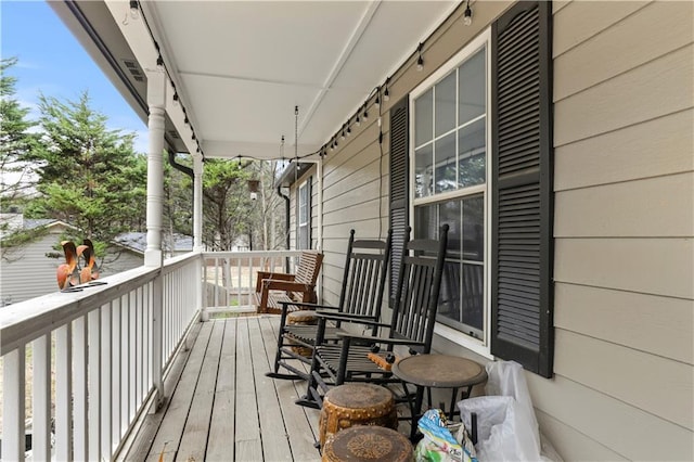 wooden terrace with a porch