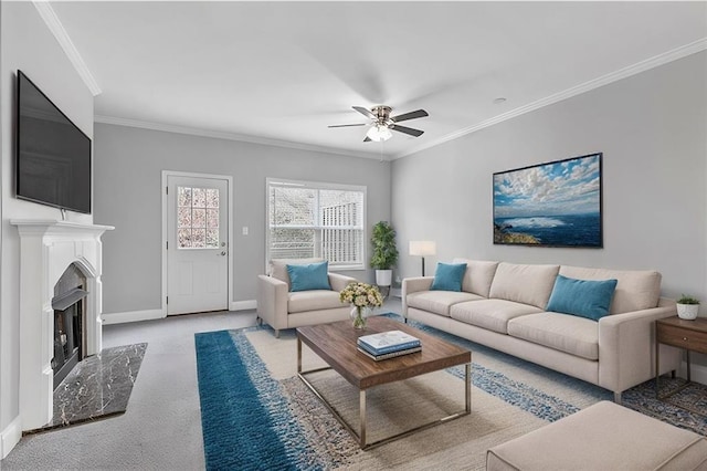 living room featuring ornamental molding, carpet, a fireplace, and baseboards