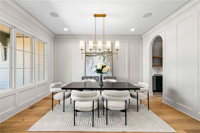 605 Claxton Ln, Milton, GA 30004 - dining room with arched walkways, a decorative wall, visible vents, and a chandelier