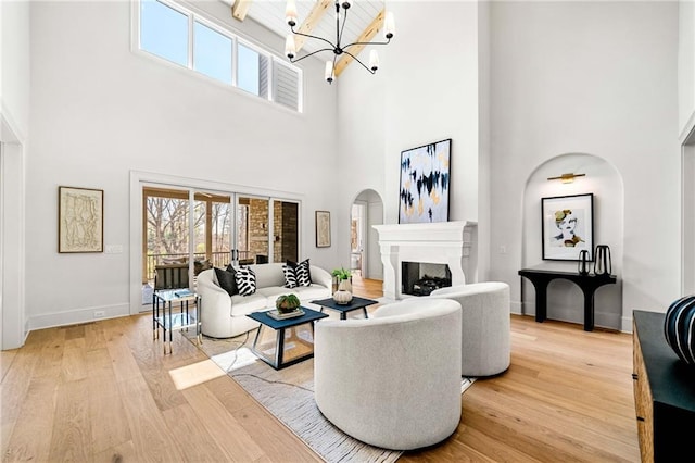 605 Claxton Ln, Milton, GA 30004 - living area with a healthy amount of sunlight, light wood-type flooring, a fireplace, and a chandelier