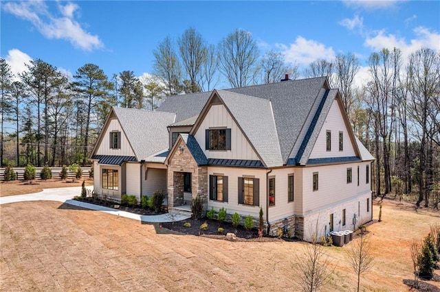 605 Claxton Ln, Milton, GA 30004 - view of front of house featuring metal roof, central air condition unit, a standing seam roof, board and batten siding, and a shingled roof