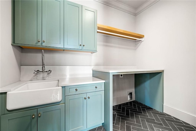 605 Claxton Ln, Milton, GA 30004 - clothes washing area featuring crown molding, baseboards, a sink, brick floor, and cabinet space
