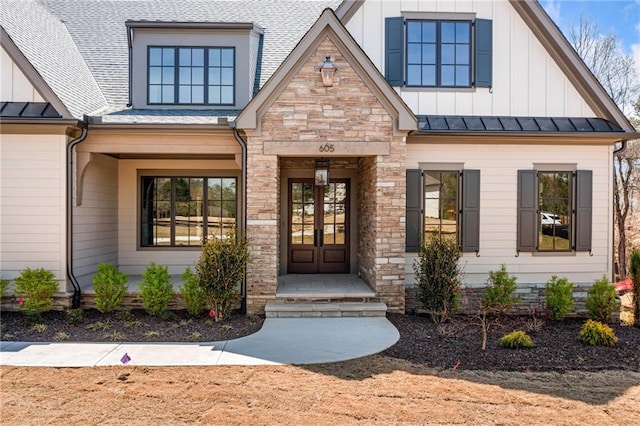 605 Claxton Ln, Milton, GA 30004 - property entrance with french doors, board and batten siding, a standing seam roof, and stone siding
