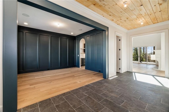 interior space featuring wooden ceiling, ornamental molding, and dark hardwood / wood-style floors