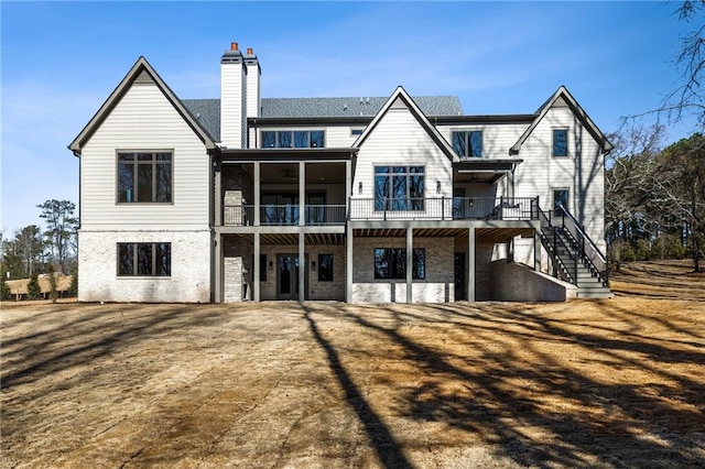 605 Claxton Ln, Milton, GA 30004 - rear view of house featuring a wooden deck, stairway, and a chimney