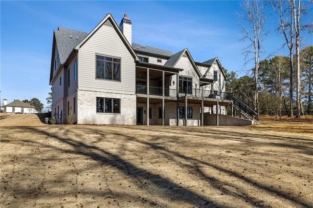 605 Claxton Ln, Milton, GA 30004 - back of house featuring a wooden deck, brick siding, stairs, and a chimney