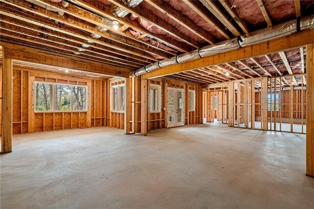 interior space with light wood-type flooring and vaulted ceiling