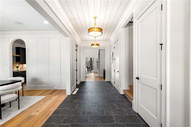 entrance foyer featuring ornamental molding and hardwood / wood-style flooring