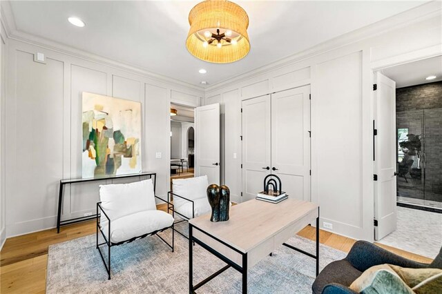 kitchen featuring a wealth of natural light, backsplash, light hardwood / wood-style flooring, and light stone countertops