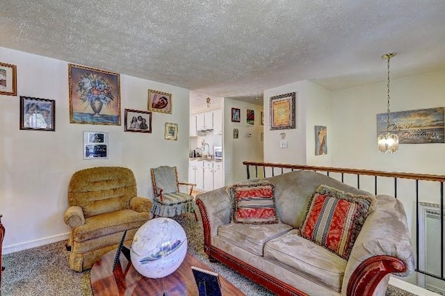 3576 Shrewsbury Ct, Snellville, GA 30039 - carpeted living area with baseboards, a textured ceiling, a sink, and an inviting chandelier