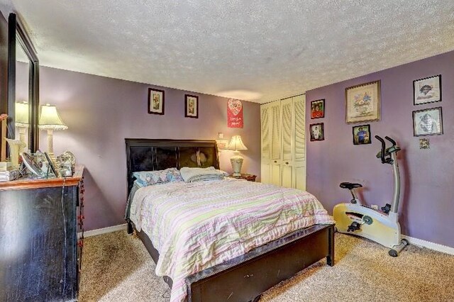 3576 Shrewsbury Ct, Snellville, GA 30039 - bedroom with baseboards, a closet, carpet flooring, and a textured ceiling