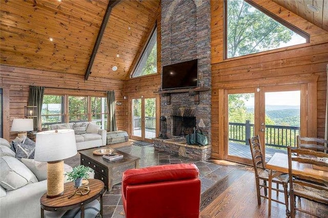 1363 Foxhound Trl, Ranger, GA 30734 - living room featuring high vaulted ceiling, wood walls, french doors, a wooden ceiling with exposed beams, and a fireplace