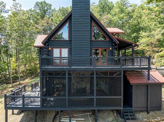 1363 Foxhound Trl, Ranger, GA 30734 - back of house featuring a wooden deck, log exterior, a metal roof, and a chimney