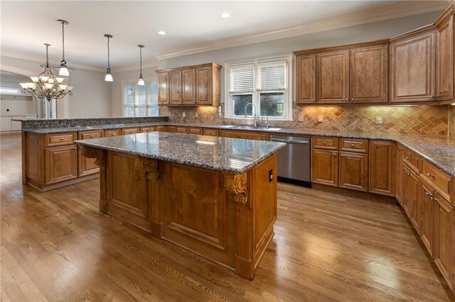 kitchen featuring dishwasher, sink, hardwood / wood-style flooring, and a center island