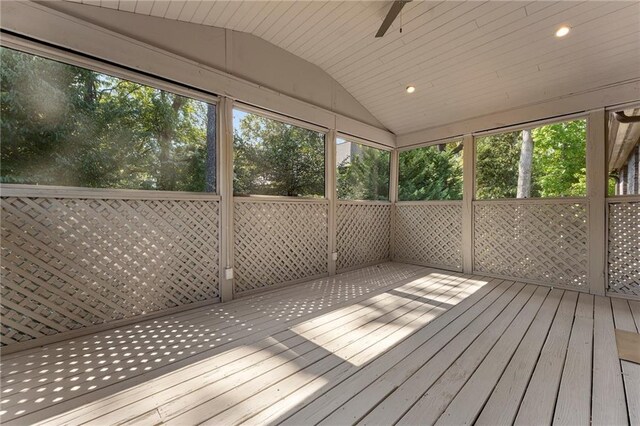 unfurnished sunroom featuring ceiling fan, lofted ceiling, and plenty of natural light