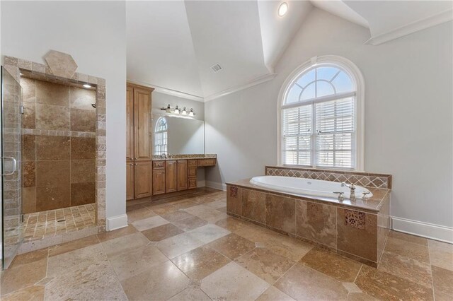 bathroom with high vaulted ceiling, vanity, and independent shower and bath