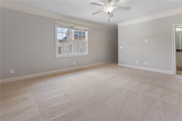 unfurnished room featuring ornamental molding, light colored carpet, and ceiling fan