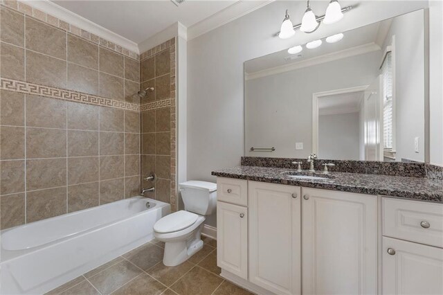 full bathroom with vanity, tiled shower / bath combo, tile patterned floors, crown molding, and toilet