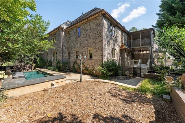 back of house featuring a fenced in pool and a patio area