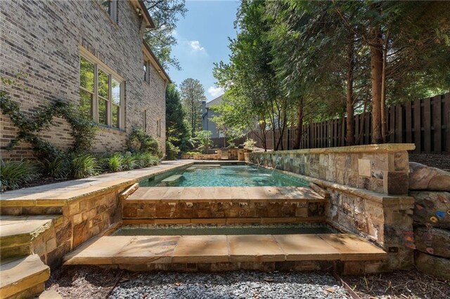 view of pool featuring pool water feature